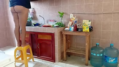 chubby stepmother washes and cleans the kitchen